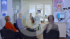 Patients with protection masks wating doctor in dental clinic