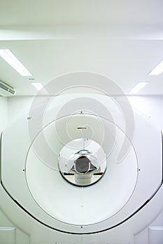 Patients screening on CT scanner. Man Undergoing CT Scan While Doctor`s Using Computers.