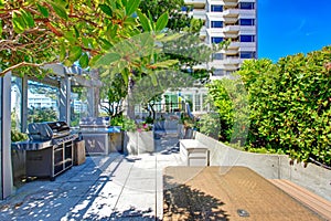 Patio area with barbecue. Residential building in downtown, Seat