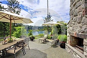 Patio area with concrete floor, patio table set and deck chairs.