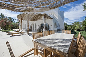 Patio area with dining table at a luxury tropical holiday villa