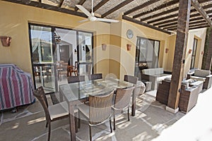 Patio area with sofa and dining table at a luxury tropical holiday villa resort