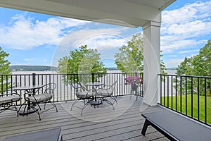 a patio with a couch and tables with chairs on it,  in Lakeport New Hampshire.