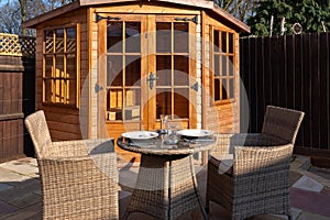 A patio in the sun with table and chairs ready for outdoor dining