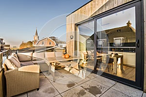 a patio with a table and chairs and a balcony