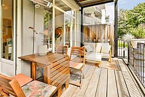 a patio with a table and chairs on a porch