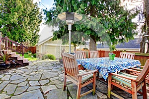 Patio with wood table set and heat lapm