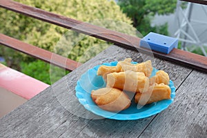 Patonggo on a blue plastic plate on a wooden background