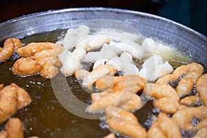 Patongko is being fried in a large pan. Breakfast for early risers