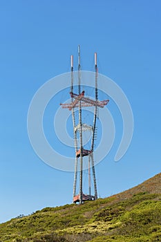 patrial sutro tower with grassy hillside foreground photo
