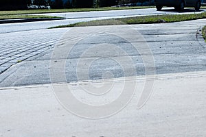 Patrially cleaned and partial irty cement sidewalk in front of a homeafter some of it has been pressure washed.