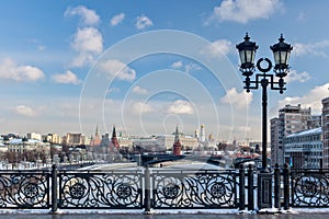 Moscow, Russia - February 22, 2018: Patriarshy Bridge, Fence and Lantern, Kremlin and the Variety Theatre, bridge and Moscow river photo