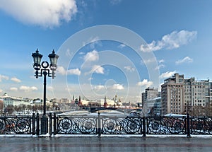 Moscow, Russia - February 22, 2018: Patriarshy Bridge, Fence and Lantern, Kremlin and the Variety Theatre, bridge and Moscow river photo