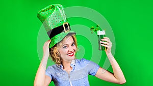 Patricks Day pab party. Happy woman in leprechaun hat with green beer. Smiling girl in green hat drinking green beer