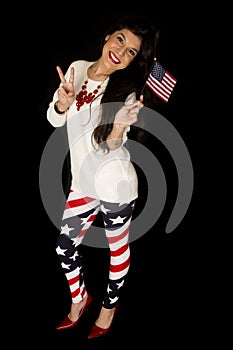 Patriotic female holding an American flag showing the peace sign