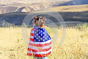 Patriotic holiday. Happy kid, cute little child girl with American flag. USA celebrate 4th of July.