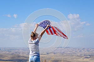 Patriotic holiday. Happy kid, cute little child girl with American flag. USA celebrate 4th of July.