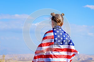 Patriotic holiday. Happy kid, cute little child girl with American flag. USA celebrate 4th of July.