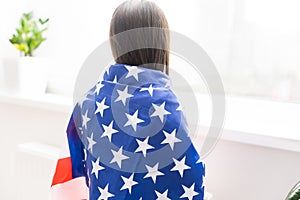 Patriotic holiday. Happy kid, cute little child girl with American flag. USA celebrate 4th of July.