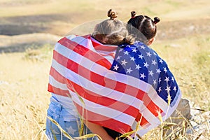 Patriotic holiday. Happy kids, cute little children girls with American flag. USA celebrate 4th of July.