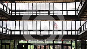 Patriotic Scene: American Flag Waving in Front of Corporate Office Building. Proudly Displayed Flag in Business Center