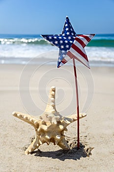 Patriotic USA background with starfish on the sandy beach