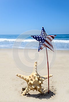 Patriotic USA background with starfish on the sandy beach