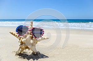 Patriotic USA background with starfish on the sandy beach