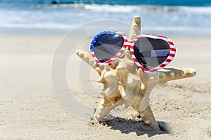 Patriotic USA background with starfish on the sandy beach