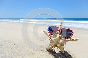 Patriotic USA background with starfish on the sandy beach