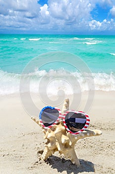 Patriotic USA background with starfish on the sandy beach