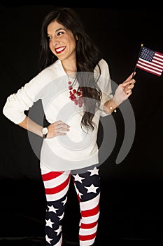 Patriotic woman with an American flag and wearing flag leggings