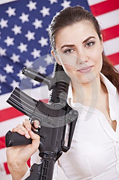 Patriotic woman with gun over american flag