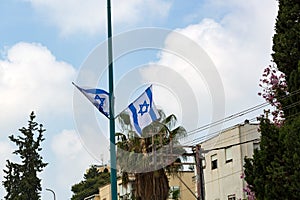 Patriotism in Israel. A row of flags of Israel in front of the Israeli parliament Knesset. Israeli flags against the sky. Israel I