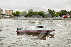 Patrol boat on river in city on summer