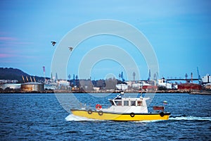 Patrol boat sailing at sunrise in sea water