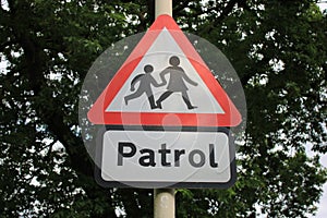 Patrol sign with children triangular sign warning motorists of crossing children