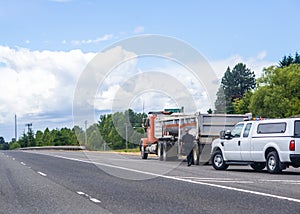 Patrolman stopped big rig tip truck and goes to inspect it