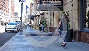 Patrons enjoy shady sidewalk dining on Broadway, Portland, Oregon