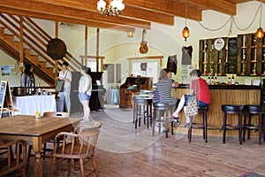 Patrons relax at tasting room bar, Harris Bridge Vineyard, Oregon