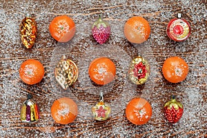 Pattern of antique Christmas toys and tangerines on a Board covered with frost