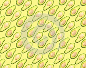 Pattern of avocado halves on pale background