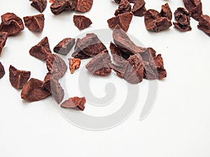 Pattern background of a Indian betelnut slices isolated on a white background