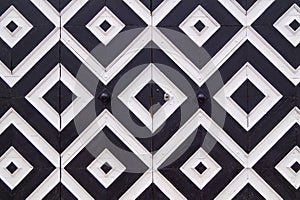 Pattern of black and white rhombuses on old doors