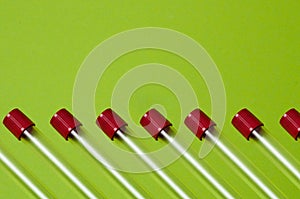 Pattern, blood collection tubes on a green background