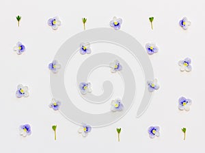 Pattern with blue flower petals and green leaves on a white background