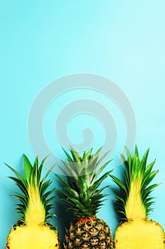 Pattern with bright pineapples on blue background. Top View. Copy Space. Minimal style. Pop art design, creative summer