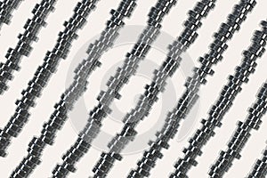 Pattern of brushed metal cylinder tablets on white background