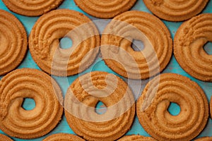 Pattern of butter cookies/biscuits on wooden teal green rustic background, flat lay design with butter cookies photo
