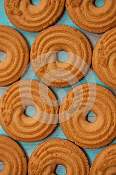 Pattern of butter cookies/biscuits on wooden teal green rustic background, flat lay design with butter cookies photo
